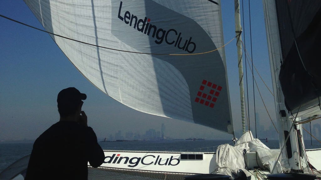 A sailing scene featuring a LendingClub-branded sailboat on open water, with a person observing the journey. The image represents financial services, lending, freedom, and forward progress, using sailing as a visual metaphor for navigating financial opportunities.