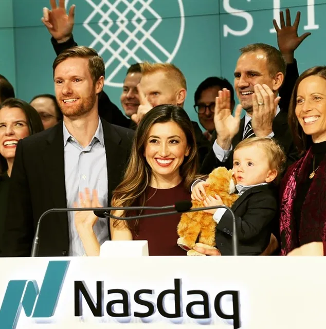 This image is suitable for content about Nasdaq, stock market listings, financial markets, and business milestones. It shows a family celebrating at the Nasdaq podium, making it useful for articles about IPO launches, public companies, entrepreneurship, investing, and major corporate achievements.